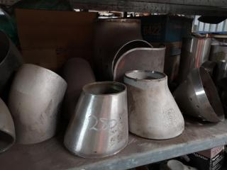 Shelf of Assorted Stainless Steel Pipe Fittings